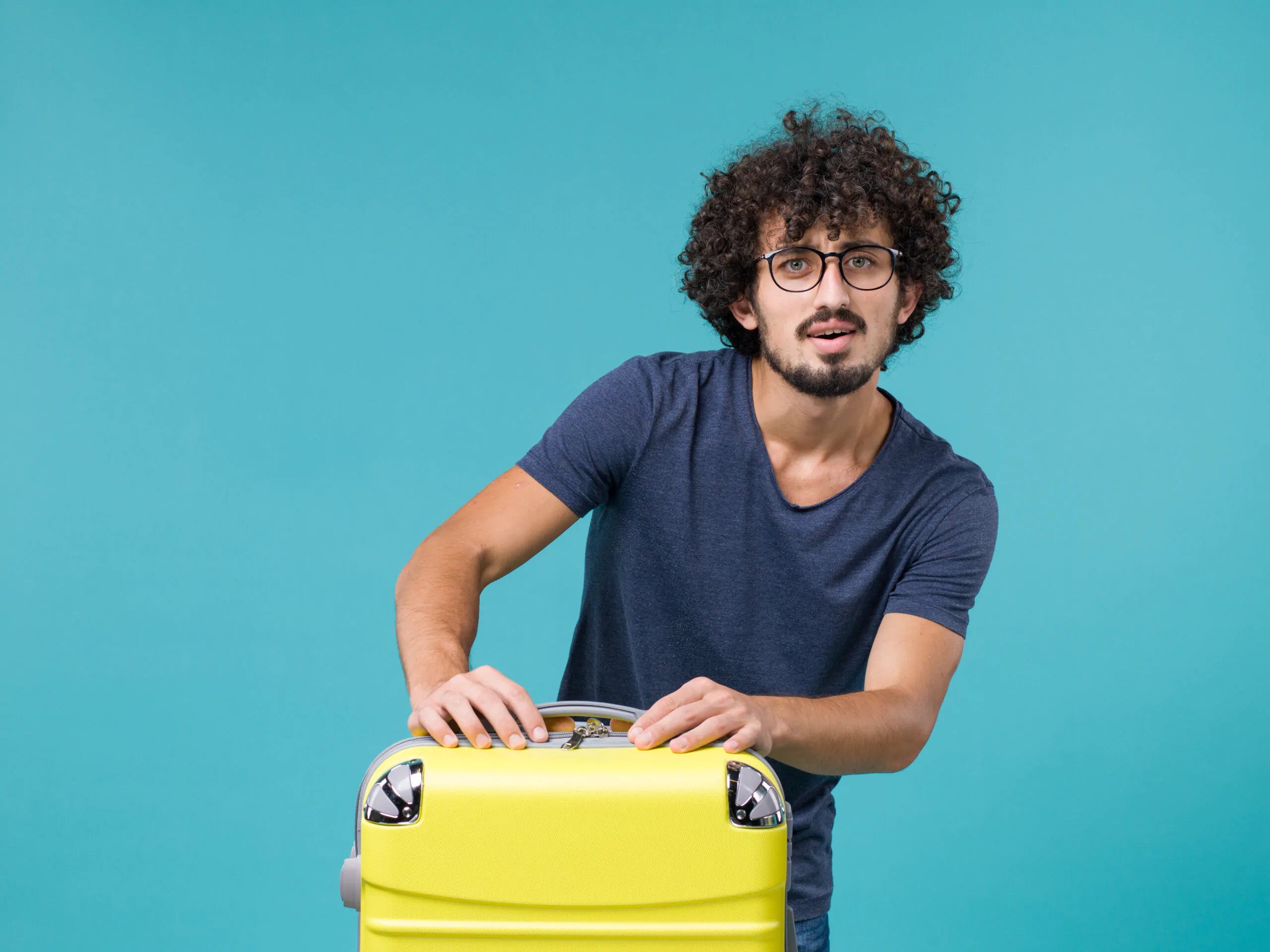 man-in-vacation-with-big-suitcase-on-light-blue Proceso de contratación de personal foráneo